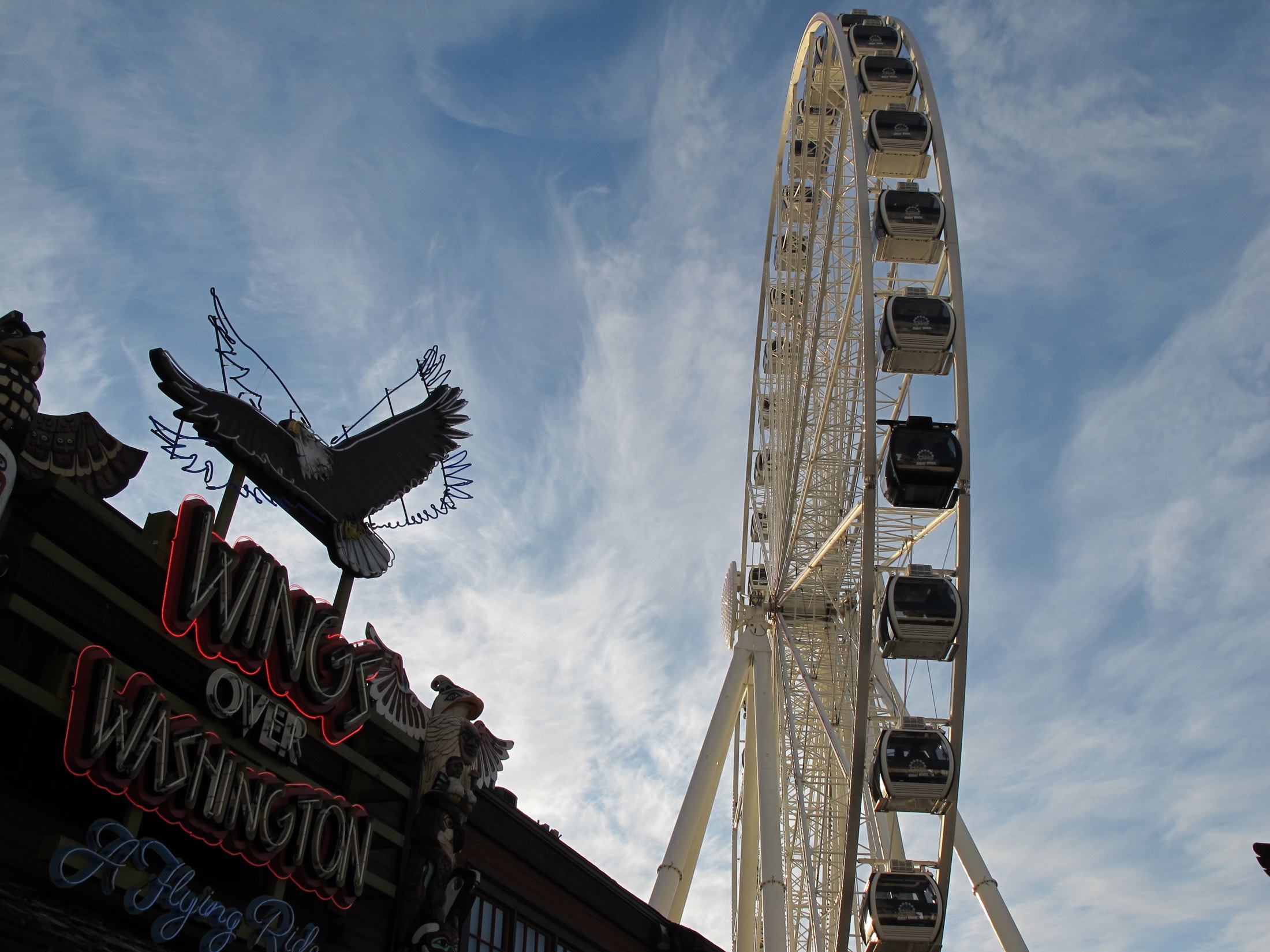 Seattle Great Wheel and Miner's Landing beneath a blue November sky.