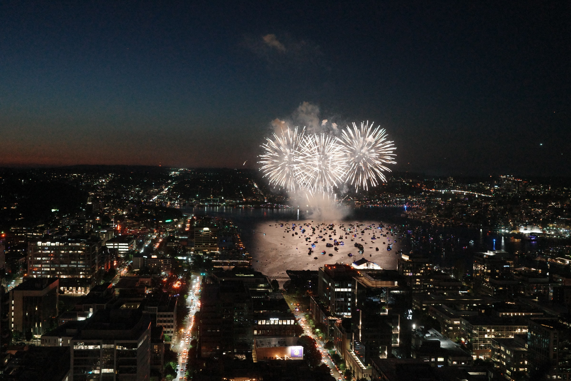 Independence Day fireworks opening over Lake Union and the Seattle skyline